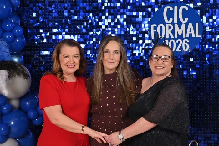 Formal guests in front of a Webber sequin backdrop